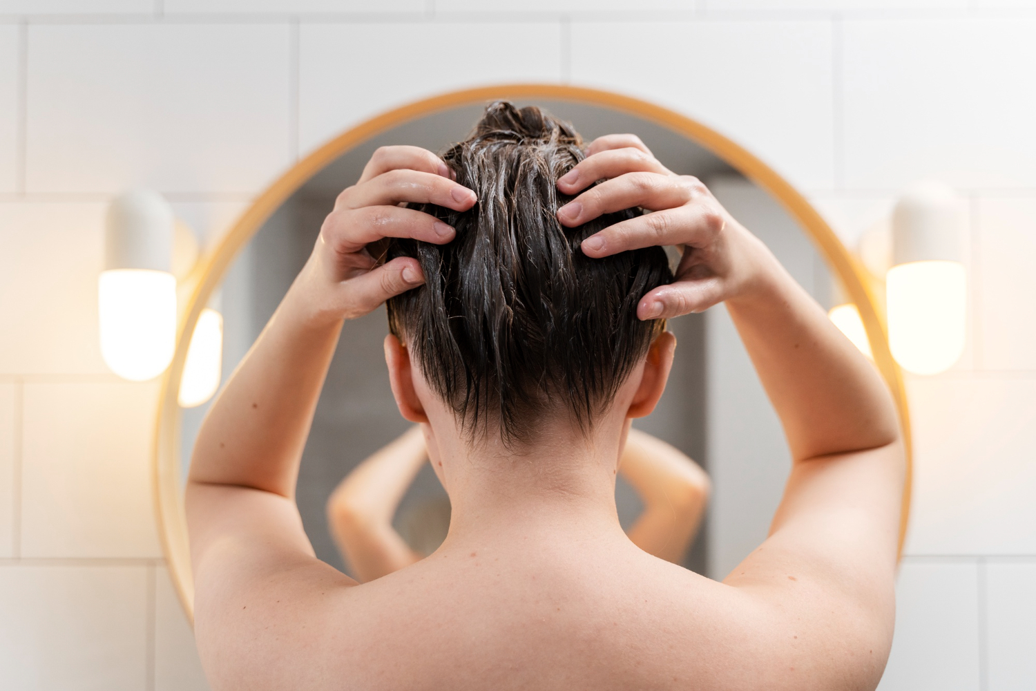 woman looking at mirror scratching head